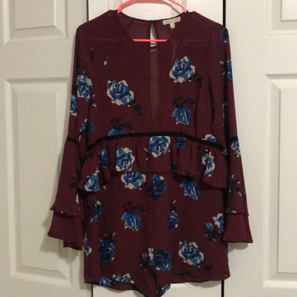 Wine colored romper with floral pattern.